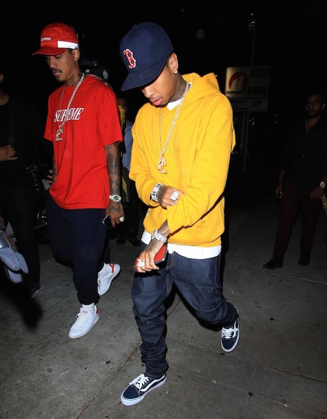 Tyga-Hops-Out-Of-His-Ferrari-wearing-Gosha-Rubchinskiy-Yellow-Hoodie-1