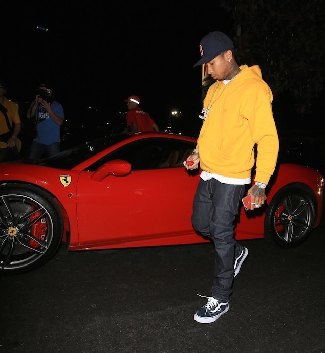 Tyga-Hops-Out-Of-His-Ferrari-wearing-Gosha-Rubchinskiy-Yellow-Hoodie