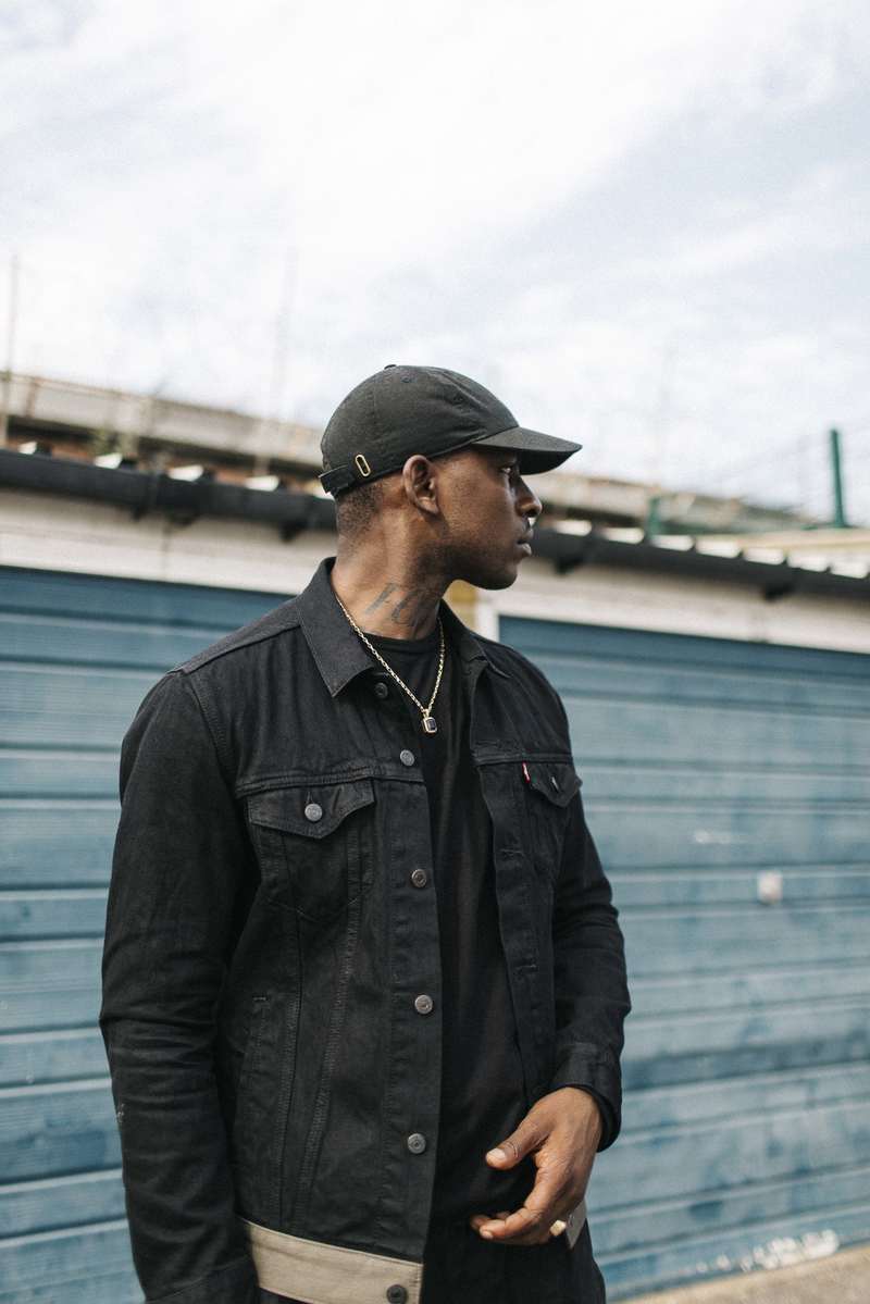 Skepta SupportMusic project wearing Levis cap and jacket